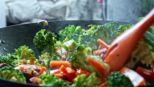 Thoroughly Blending Seasonings In Cooking Of Vibrant Stir-Fried Veggies - A Tasty Choice For Vegetarians