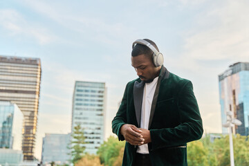 businessman hipster listening to music with headphones dressed in a smart suit