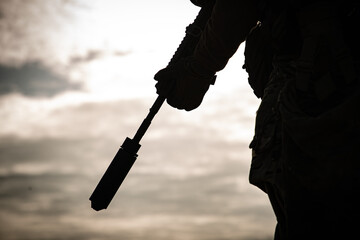 silhouette of a man holding a rifle