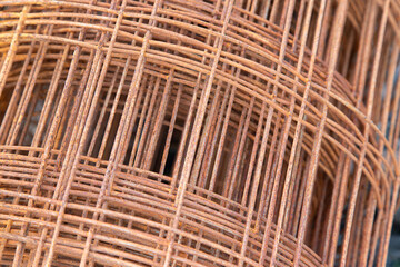 Roll of steel mesh for construction in oxidation state. Abstract image.