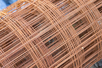 Roll of steel mesh for construction in oxidation state. Abstract image.