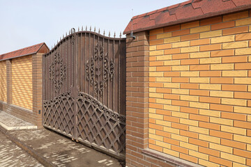 Brick wall with beautiful wrought iron gate, textured surface, Film grain effect