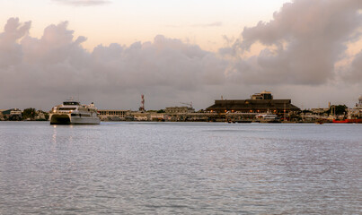 A passenger ferry sails at dusk from the main ferry terminal of Papeete, the capital of French...