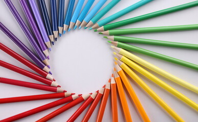 Colored pencils in acircle closeup. Colored pencils lie around on white background. Pencil drawing...