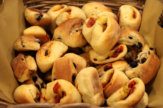 Various types of Italian puccette, also called saltimbocca. Small loaves filled with olives, frankfurters or bacon. Apulian food