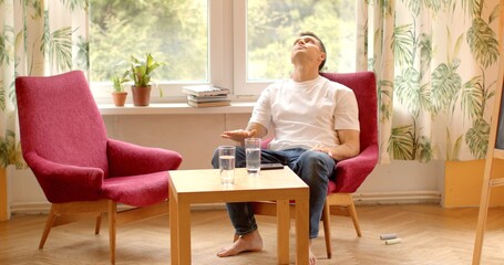 Portrait of a man waiting in a chair. With an expression of anticipation, patience and expectation. Self-reflection process of contemplation and introspection about one's thoughts, feelings, actions.