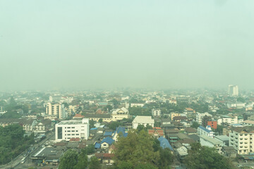 Bad air pollution with PM 2.5 (fine particulate matter) dust smog problem over Chiangmai city landscape skyline background aerial view, dangerous for human health and respiration, risk of lung cancer - 781380636