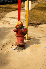 Motor vehicle struck and damaged a city fire hydrant with shattered glass and plastic nearby.