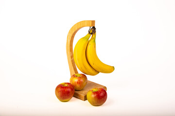 Bananas on a stand with honeycrisp apples around the base on a white background.