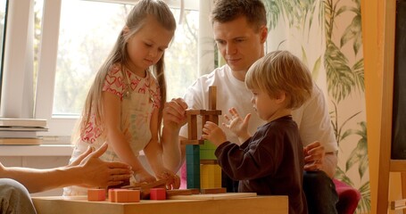 Social Skills: Playing with building blocks in a family setting provides children with...