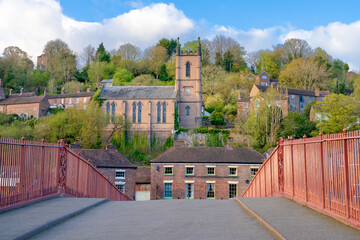View across the bridge in Ironbridge, Shropshire, UK towards the town.  With the church in the...