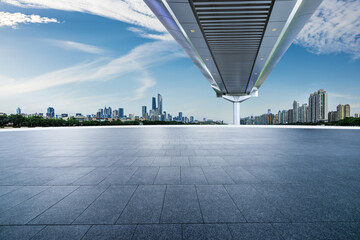 Empty square floor and pedestrian bridge with modern city buildings in Guangzhou