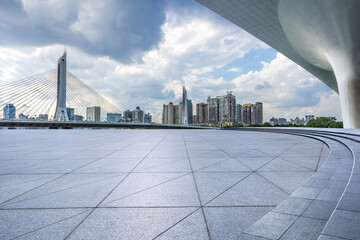 Empty square floor and bridge with city buildings in Guangzhou