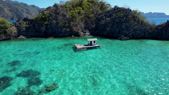 4K Aerial drone video of Siete Pecados Siete with boats surrounded by blue sea. Coron, Palawan. Philippines.
