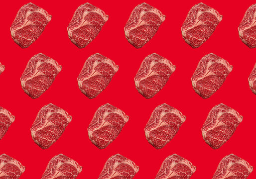 Raw Ribeye on red background
