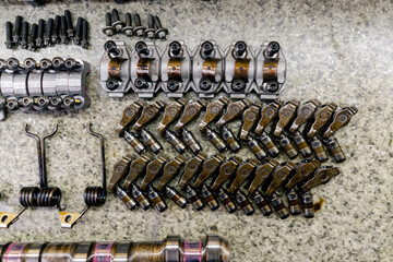close up At the service station on the table there are car spare parts from the car, spring...