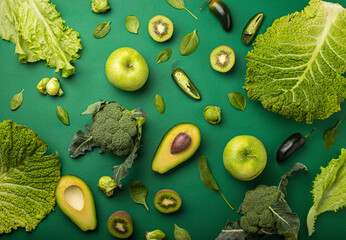 Green fruit and vegetables on green background
