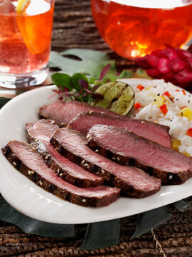 London broil beef with rice and a grilled lime