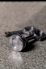 close-up At the service station of new iron piston parts lying assembled on the table
