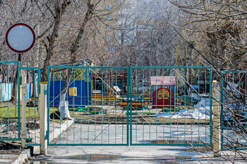 Closed gates to the kindergarten territory on a spring day