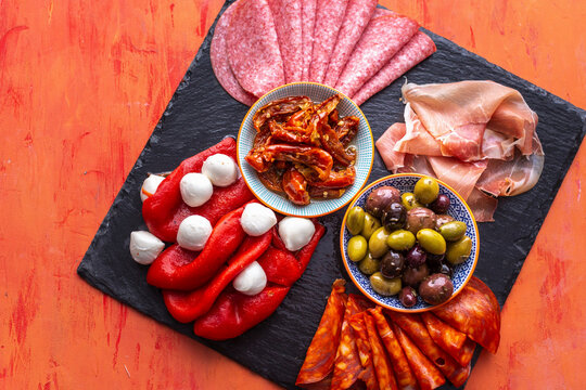 Charcuterie with chorizo, mozzarella, olives, ham, peppers, salami and tomatoes