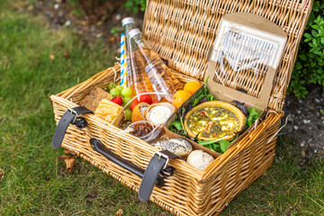 Picnic basket with quiche, salad, rolls and fruit