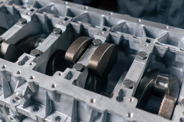 close up The crankshaft set of pistons close-up on desktop of an auto mechanic Spare parts of the...