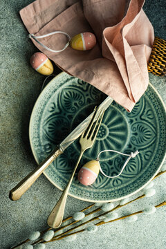 Easter table setting with decorative Easter eggs, cloth napkin and pussy willow