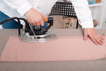 The seamstresses workplace. The dressmaker cuts out details along the lines of the sketch.