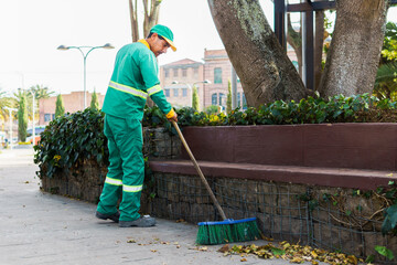 A street sweeper is sweeping the garbage found in a park