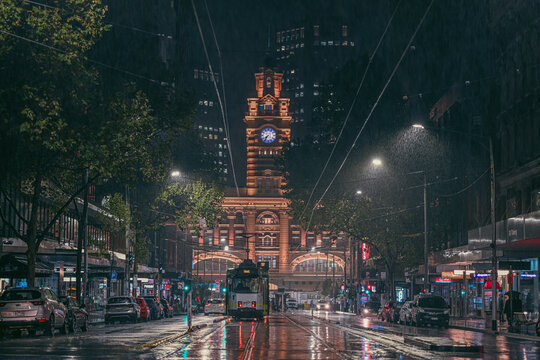 A tram in front of Flinders Street Station, Melbourne, on a cold winter rainy night.