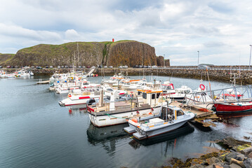 Fishing harbour in Iceland under overcast sky in summer
