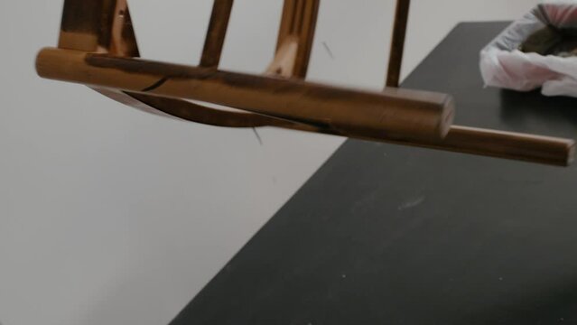 Restoration of a wooden chair. Covering with dark varnish. Close-up. Vintage things. High quality 4k footage