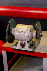 close-up At the service station on the table there is machine for metal carving with different...