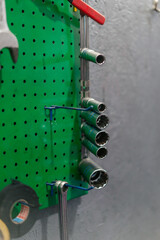close-up of service station on a green wall in a suspended state of different diameter nozzles for...