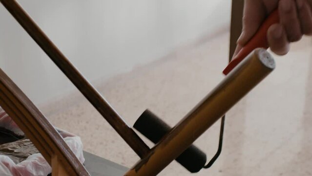 Restoration of a wooden chair. Covering with dark varnish. Close-up. Vintage things. High quality 4k footage