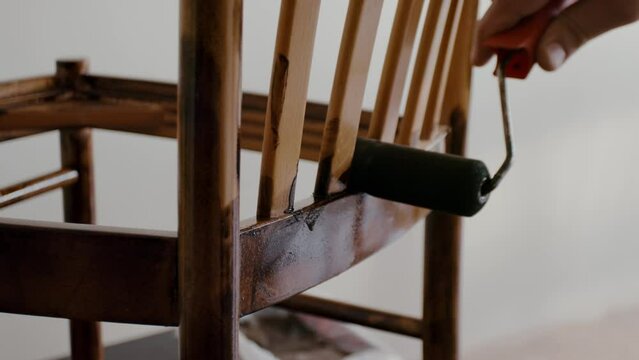 Restoration of a wooden chair. Covering with dark varnish. Close-up. Vintage things. High quality 4k footage