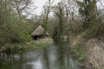 Thatched Fishing Hut on the River Test Hampshire England in spring