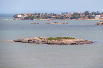 View of a small island on Camburi beach in Espírito Santo.