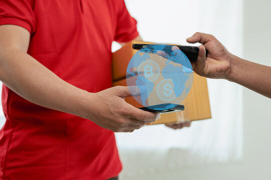 A person wearing a red T-shirt is delivering a package to a satisfied customer. friendly staff High quality courier service with cardboard boxes delivering parcels to customers. Courier delivers parce