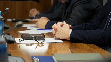 Business team of three men during a business meeting or negotiation. Photo. No face. Selective...
