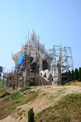 Fototapeta na wymiar Thai people workers renovate repair and build scaffolding structure at ancient ruins ubosot or antique building ordination halls of Wat Huay Pla Kang temple at Chiangrai city in Chiang Rai, Thailand