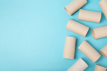Empty toilet paper roll. Rolls of toilet paper on a blue background. Paper tube of toilet paper. Place for text. Copy space. Flat lay. Eco-friendly reuse recycle