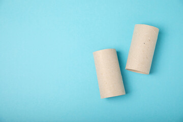Empty toilet paper roll. Rolls of toilet paper on a blue background. Paper tube of toilet paper....