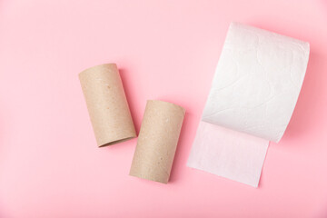 Empty toilet paper roll. Empty toilet paper rolls  for on pink background. Paper tube of toilet paper. Place for text. Copy space. Flat lay. Eco-friendly reuse recycle