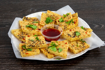 A plate of traditional Indian or Pakistani snack Khaman or yellow dhokla