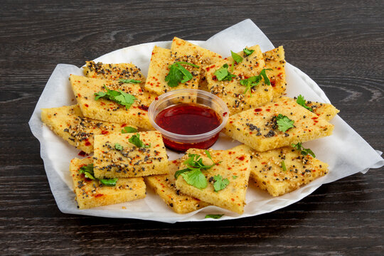 A plate of traditional Indian or Pakistani snack Khaman or yellow dhokla