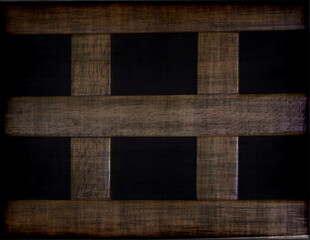 A dark wooden panel structure pattern in close up