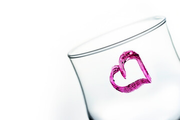 One glass with heart shape in purple color