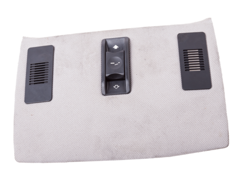 Close-up of roof light control dashboard and sunroof buttons of luxury very expensive new white car in the vehicle repair workshop on white isolated background. Auto service industry.